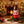 XT Brewing Co XT25 Christmas Ale Dark Red 2-Litre Plastic Bottle with a fireplace and golden lights Christmasy background.